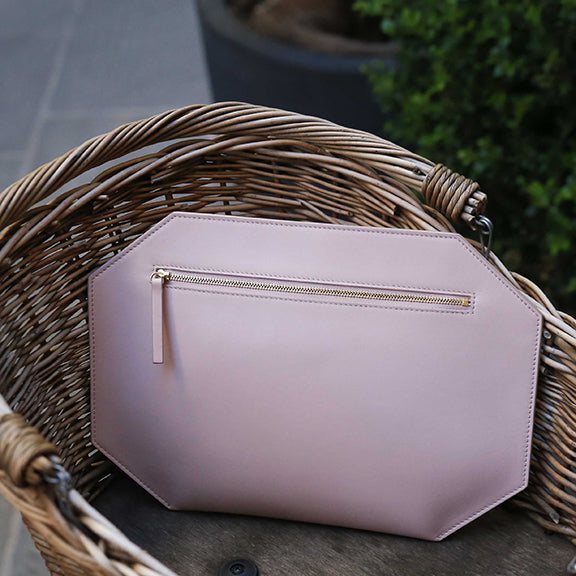 CHANDRA KEYSER oversized leather zipper clutch bag, made in Italy. Pink purse sitting in a basket