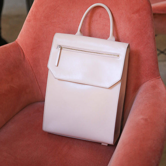 CHANDRA KEYSER Lo Zaino pink convertible backpack, work bag, made in Italy. Pink leather backpack sitting on a pink velvet chair