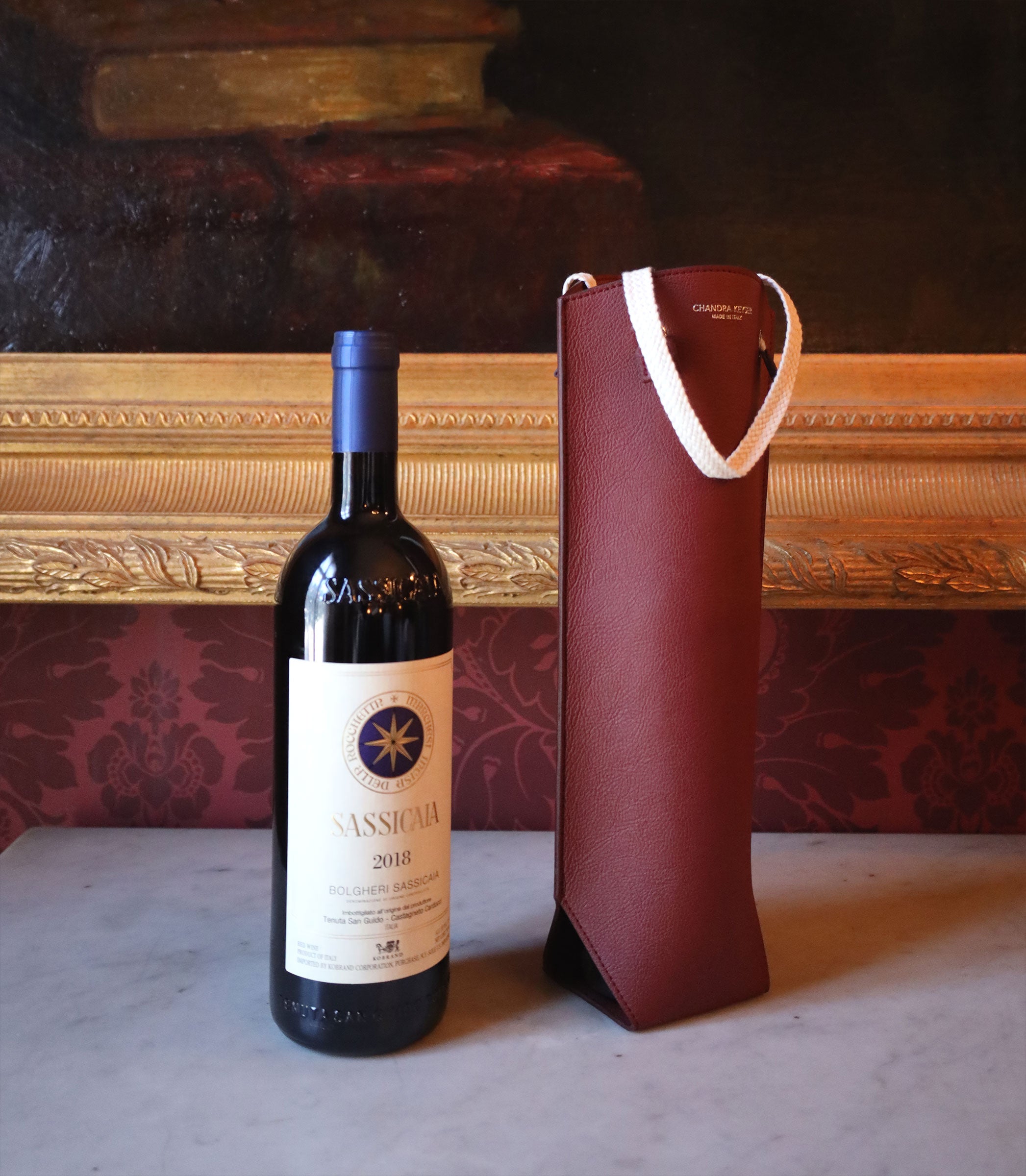 Chandra Keyser Sustainable Luxury Wine Carrier with Sassicaia wine. The wine tote is made from apple waste and meant to be gifted and regifted to support zero-waste fashion.