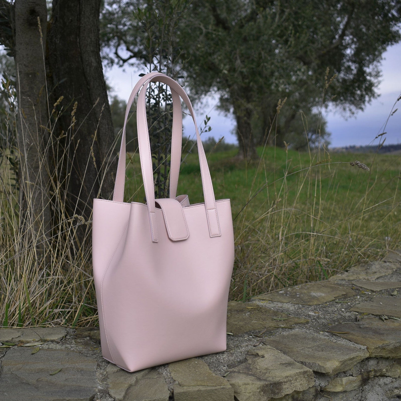 Chandra Keyser made in Italy La Borsa leather bag. Pink tote bag on a stone wall with a natural background