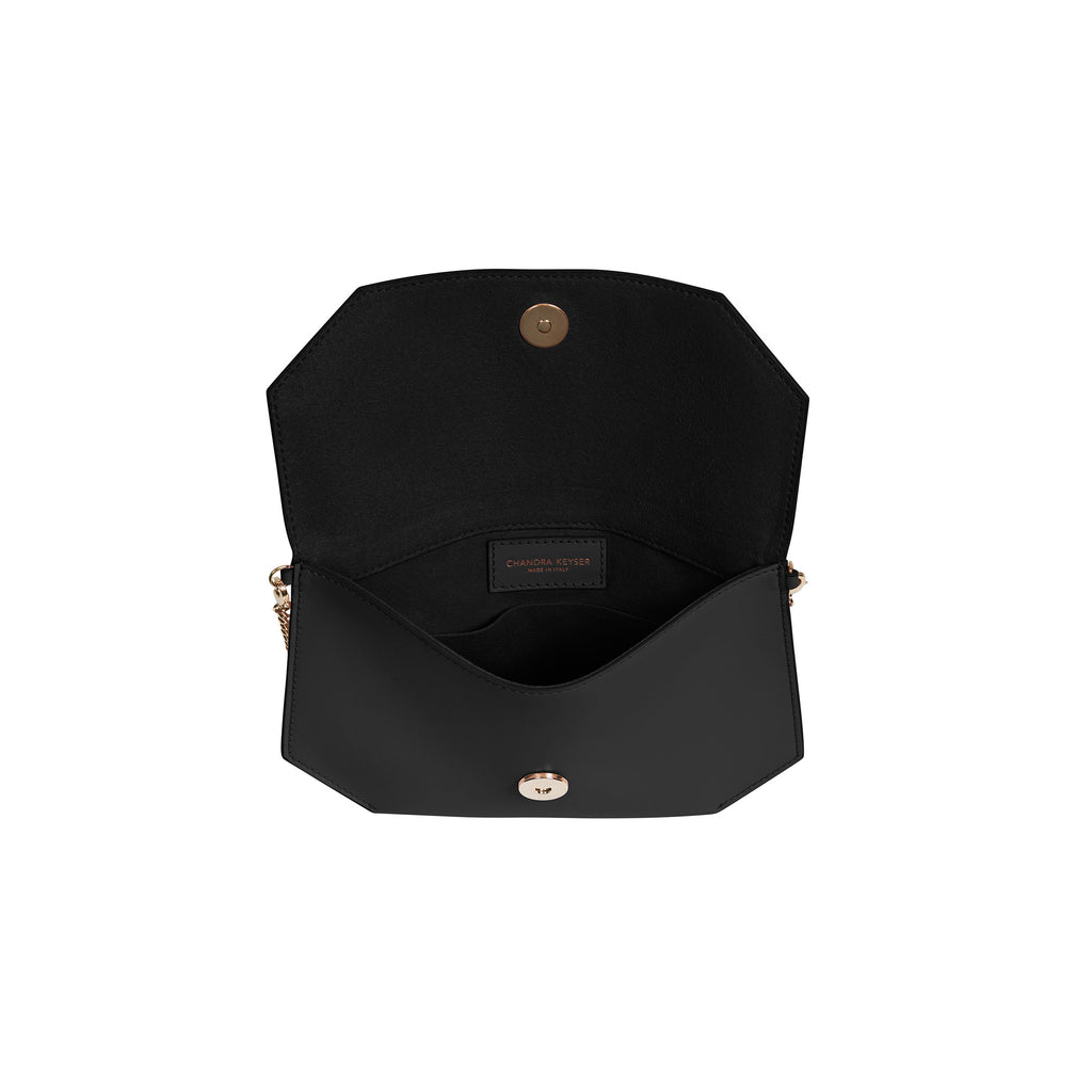 Cross body purse made with exceptional quality leather. Carry as an evening bag or clutch with removable chain strap. Sleek design comfortably fits a phone, sunglasses and keys.  100% smooth matte leather Magnet snap closure Micro-suede lining, with inside open pocket Detachable chain shoulder strap, 22” drop Measures: 5.5”h x 8.5”w x .75”d Handcrafted by artisans in a family-owned factory Exclusively made in Italy